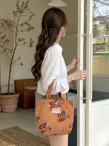 Corduroy tote bag with colorful Keep Smiling prints and top handles in beige