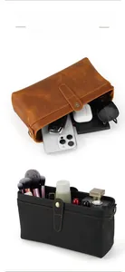 Macro detail of high-capacity leather toiletry bag with visible contrast stitching