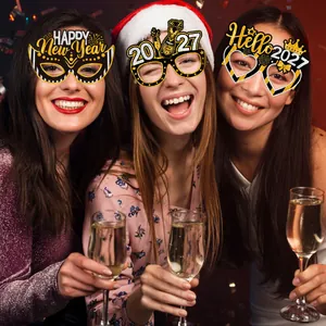 Close-up of 2027 New Year party glasses with gold glitter finish and festive designs