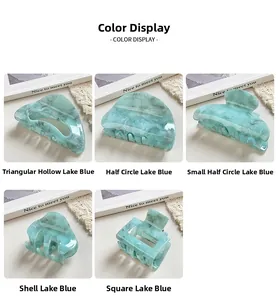 Detail view of lake blue acrylic hair claws in five geometric marbled texture shapes