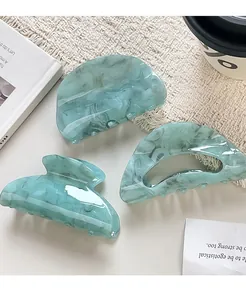 Three-piece set of marble blue acrylic hair claws including butterfly and hollow styles