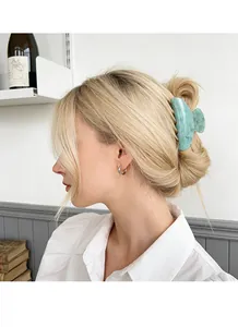 Detail shot of light green marble texture acrylic hair claw clip worn by a model