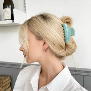 Mint green marble acrylic hair claw clip accessory shown in elegant hairstyle