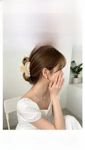 Model wearing large amber marble acrylic hair claw clip for elegant styling