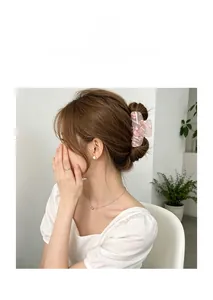 Pink floral acrylic hair claw clip shown in a stylish updo on a model's head