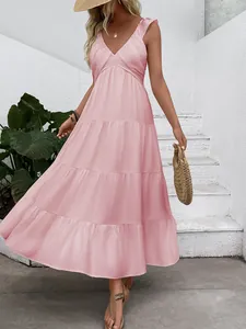 Close-up of pink layered tiered summer dress with deep V-neck and thin straps