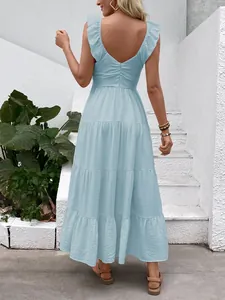 Detail view of the deep V-back and invisible zipper on a light blue summer maxi dress