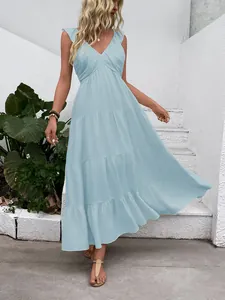 Detail of light blue tiered dress featuring a V-neckline and breathable summer fabric