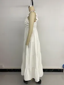 Detail of white sleeveless tiered maxi dress featuring ruffle straps and textured cotton fabric