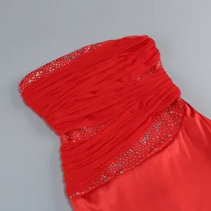 Close-up of red evening tube dress featuring silver rhinestones and horizontal pleats