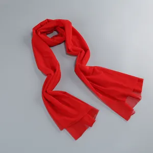 Close-up of semi-transparent red mesh fabric texture on fashion evening dress