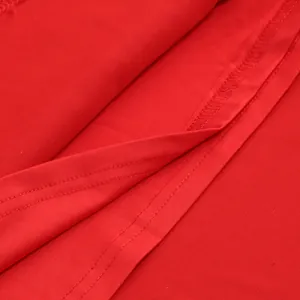 Macro detail of red slim fit dress showing high-quality fabric texture and twin-needle stitching