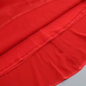 Detail shot of the red evening dress showing double stitching and fabric texture