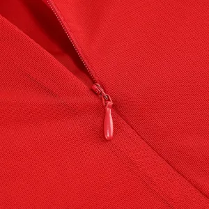 Detailed macro view of the high-quality invisible zipper on a red mesh evening dress