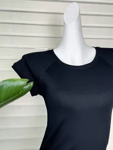 Detail shot of black ribbed knit t-shirt with raglan sleeves and round neckline