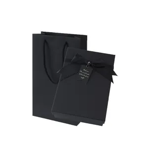 Minimalist black kraft paper gift box and matching paper bag with elegant satin ribbon