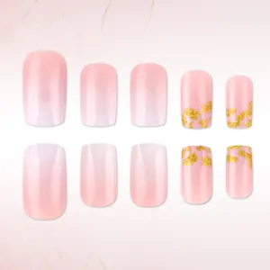 Pink gradient press-on nails with gold foil accents and a sweet square-shaped design