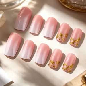 Pink and white gradient press-on nails with elegant gold foil flakes and glossy finish