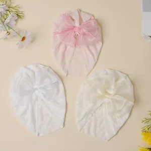 Three-piece baby turban set with lace texture and large organza bows in soft colors