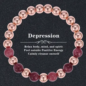 Detail of beaded bracelet featuring rose gold metal and dark purple natural stone beads