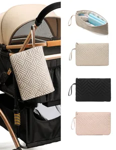 Close-up of quilted wave pattern toiletry bag hanging on a stroller handle for storage