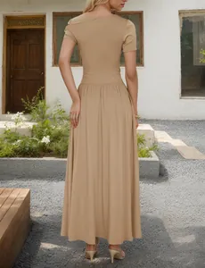 Detail of the back view of a khaki maxi dress with a pleated hem and waist cinching