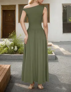 Detail of the olive green off-shoulder dress featuring waist pleats and a large skirt