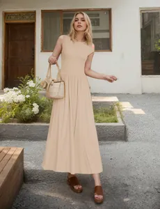 Detail view of apricot sleeveless maxi dress with pleated hem and waist design