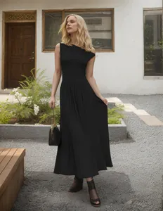Elegant outdoor fashion shot of a black sleeveless maxi dress with pockets and sandals