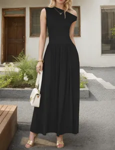 Detail of elegant black one-shoulder maxi dress with waist pleats and large flowy hemline