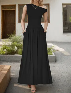 Close-up of asymmetric neckline and side pocket on a black maxi leisure dress