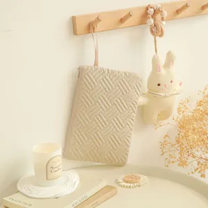 Chic quilted beige handheld makeup bag with zipper and handle for travel organization