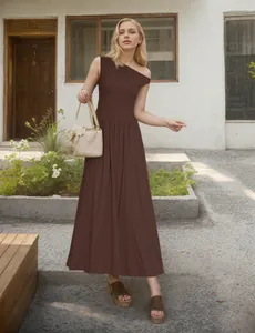 Detail of a dark brown one-shoulder maxi dress with a flowy hem and pleated fabric texture
