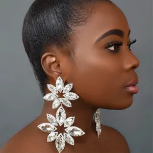 Close-up of sparkling floral rhinestone earrings featuring elegant starburst crystal design