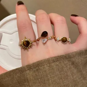 Golden sunflower ring with tiger eye stone and vintage layered stacking rings for women