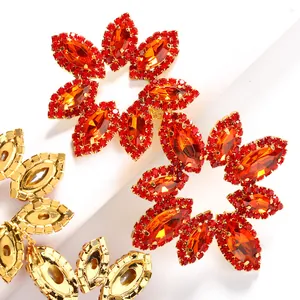 Luxurious flower shaped rhinestone earrings with red and orange stones in gold setting