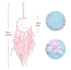 Detail view of pink moon dreamcatcher showing beadwork and soft feather textures