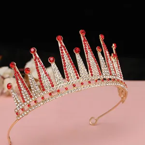 Dettaglio di una corona da sposa in cristallo con strass rossi e base in metallo dorato