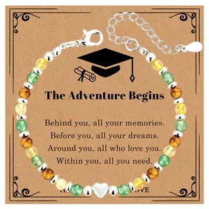 Detailed view of graduation natural stone bracelet with heart charm on a sentiment card