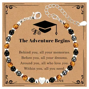 Detail view of natural stone beaded bracelet with heart pendant on graduation gift card.