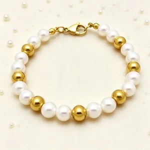 Detailed close-up of beaded bracelet with white pearls and gold metal spheres