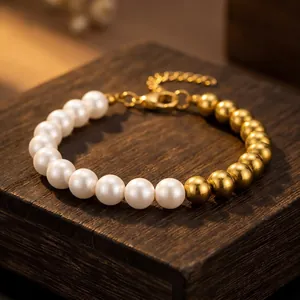 Detail showing the mixed white pearl and gold metal bead bracelet with lobster clasp