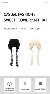Detail of hand-woven knit hat with 3D floral accent and long braided tassels