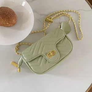 Chic green quilted chevron chain crossbody bag with gold hardware and flap closure