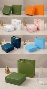 Detail of luxury corporate gift boxes in six colors with gold ribbons and Good Luck text
