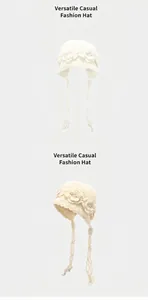 Detail view of handmade crochet beanie with floral embroidery and tassel ties