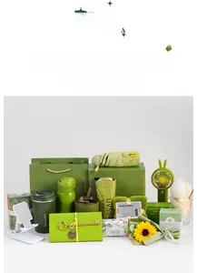 Detail view of green business gift set including umbrella, thermos, fan, and coffee mug