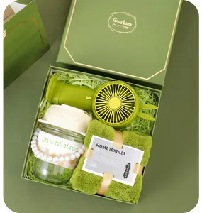 Detailed view of business gift set including green mini fan, water bottle and towel