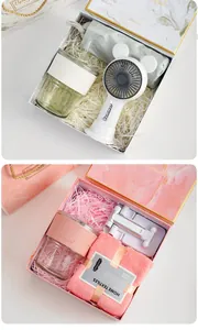 Detail of marble pattern gift box with portable fan, glass tumbler and soft face towel