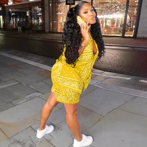 Detail of yellow two-piece set featuring white paisley print shorts and short sleeve shirt